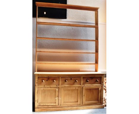 VICTORIAN PINE DRESSER, the upper section of four shelf configuration having an open back, above a base of three drawers, abo