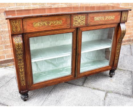 A ROSEWOOD AND BRASS INLAID DISPLAY CABINET of rectangular form, with the twin doors opening to reveal a fitted shelf and rai