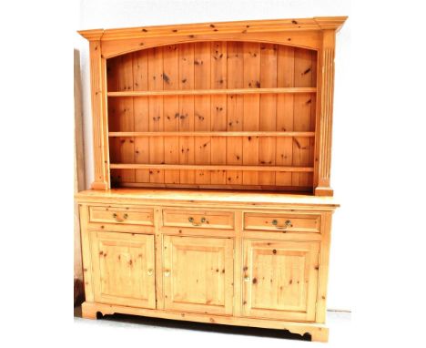 20TH CENTURY PINE DRESSER, the upper section of three shelf configuration and having a panelled back, above a base of three d