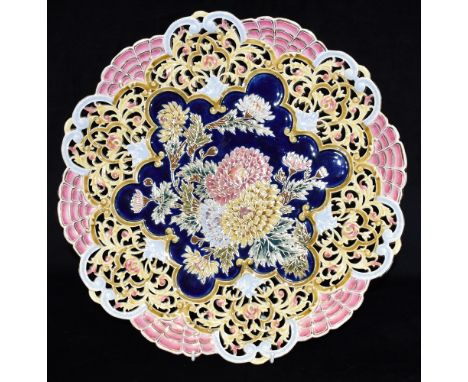 A LARGE ZSOLNAY PECS RETICULATED CHARGER  the centre polychrome enamelled with chrysanthemums on a blue ground, impressed and