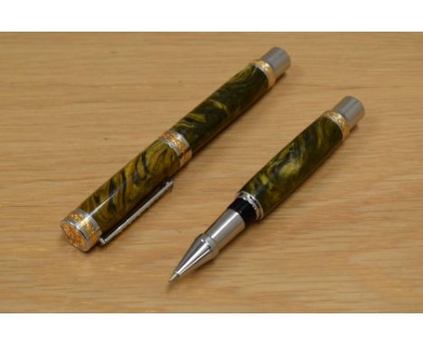 A boxed handmade converter fill fountain pen and rollerball set in green onyx with silver and gilt trim having precious stone