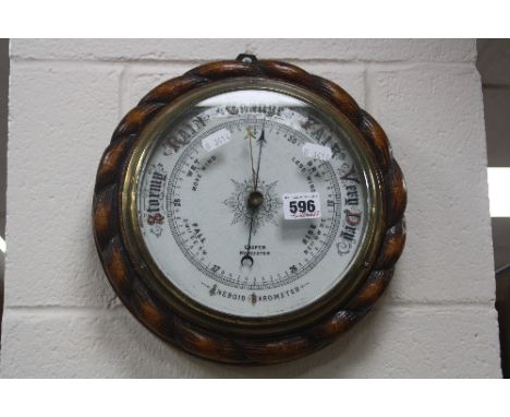 A LATE VICTORIAN OAK CASED ANEROID BAROMETER, marked Cooper of Worcester
