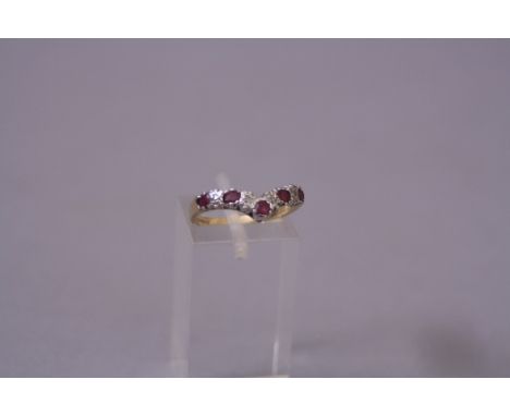 A MODERN DIAMOND AND RUBY WISHBONE RING, total diamond weight 0.04ct, ring size K, convention hallmarked 9ct gold, London, ap