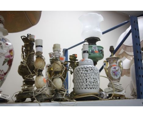 A LATE VICTORIAN OIL LAMP, with opaque glass shade, brass base, together with three ceramic table lamps and seven metal table