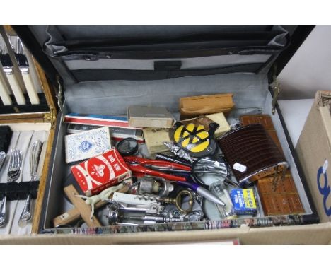 A SUITCASE OF SUNDRIES, to include corkscrews, playing cards, 'AA' badges etc