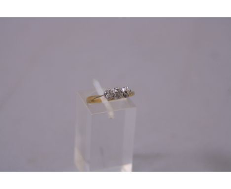 AN EARLY 20TH CENTURY THREE STONE DIAMOND RING, three old mine cut diamonds, estimated total diamond weight 0.18ct, colour as