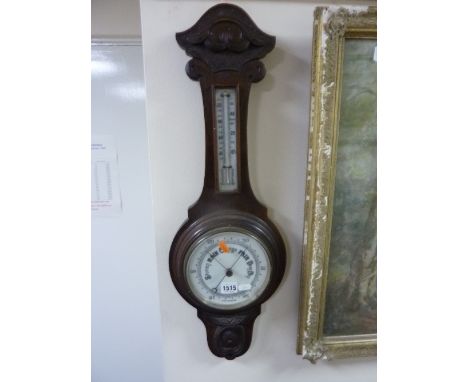 A CARVED OAK CASED BAROMETER