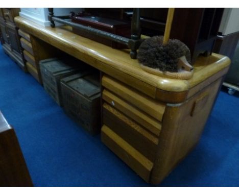 A LONG LIGHT OAK DESK, with eight drawers, approximate size width 220cm x depth 60cm x height 73cm