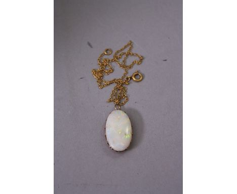 A MID-LATE 20TH CENTURY SINGLE STONE OPAL PENDANT, one shallow oval cabochon cut white opal measuring approximately 24.0mm x 