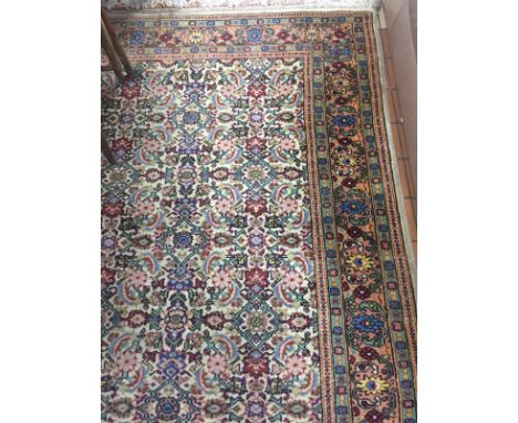 A LARGE MULTI-COLOURED CARPET, approximate size 355cm x 250cm, 'Persian Carpet' label to underside