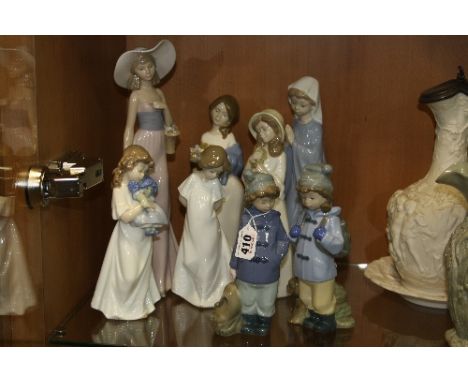 SIX NAO FIGURES AND OTHERS, to include two children in duffle coats, hats and gloves, with ruck sacks, two girls in nightdres