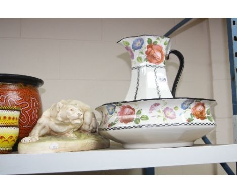 A ROYAL DUX STYLE FIGURE OF A CROUCHING TIGER, together with an H & K of Tunstall wash jug and bowl (3)