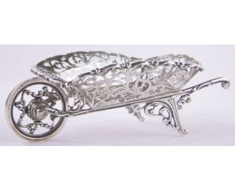 An Edwardian ornamental silver wheelbarrow,pierced fretwork surround, makers marks G N R H , Chester 1907, length 14cm.