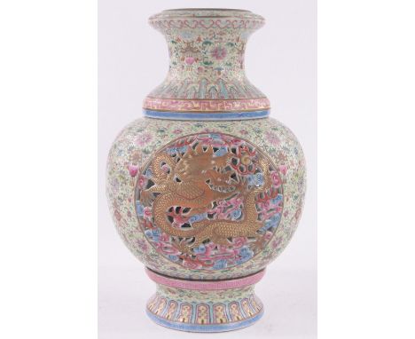 A Chinese porcelain 3-section lamp vase,the finely enamel painted outer part having pierced and gilded dragon panels, with in