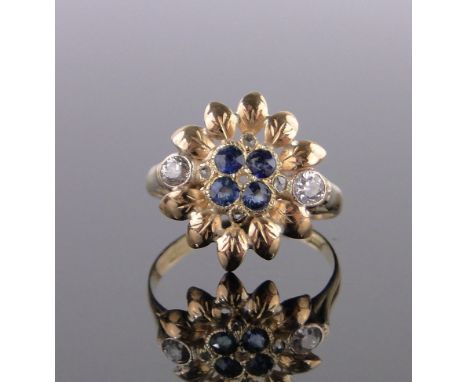 An 18ct sapphire and diamond flower head design ring,setting height 18mm, size R.