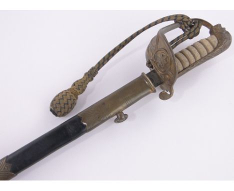 An early 20th century Navy Officer's dress sword,shagreen handle with gilt brass basket hilt, etched blade inscribed London M