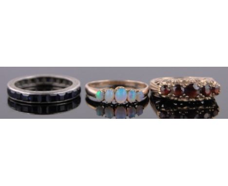 A sapphire eternity ring,unmarked white gold settings, size M, a 5 stone opal and gold ring and a 9ct 5 stone garnet set ring