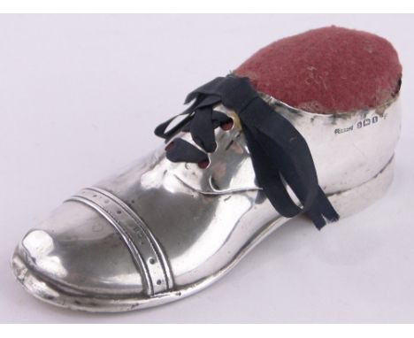 An Edwardian silver Oxford Brogue shoe design pin cushion,Birmingham 1910, length 12cm.