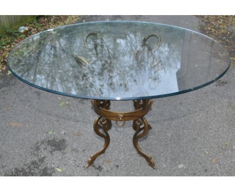 A modern circular glass top centre table raised on a stylised painted metal ring design base,width 3'11", height 2'6".