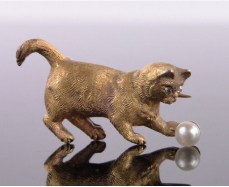 An 18ct gold pearl and diamond brooch in the form of a cat playing with a ball,circa 1900, 6g, length 2.5cm, original fitted 