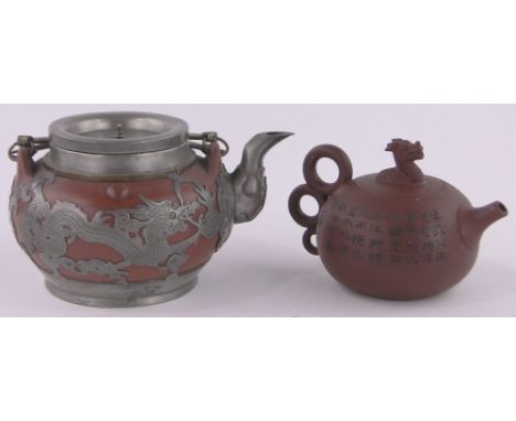 A Chinese ceramic Redware teapot with pewter mounts,and a smaller Redware teapot with incised text, (2).