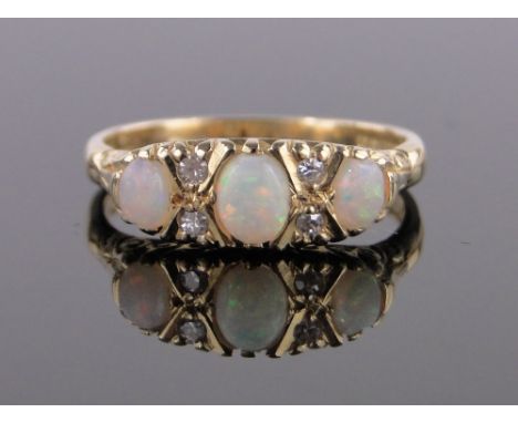 An 18ct gold opal and diamond ring,with carved settings, size O.