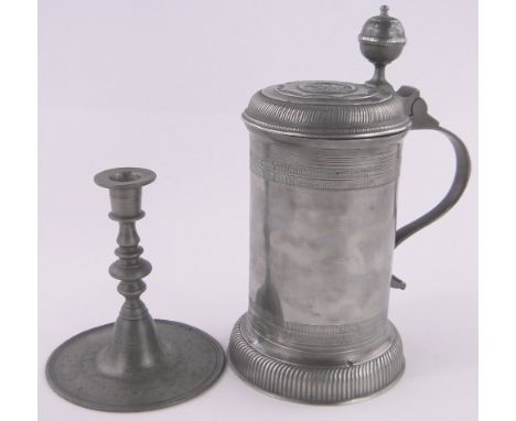 A German pewter lidded tankard,height 20cm and a German pewter candlestick, (2).