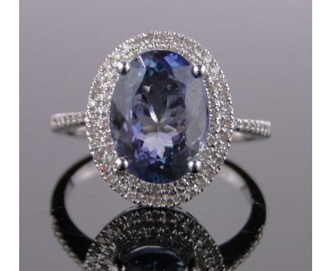 A 14ct white gold tanzanite and diamond cluster ring,tanzanite approx. 3.57cts, total diamond content approx. 0.64cts, settin