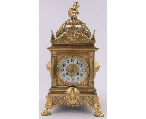 A 19th century ornate French cast brass cased mantel clock,surmounted by a musical cherub, enamel dial and 8-day striking mov