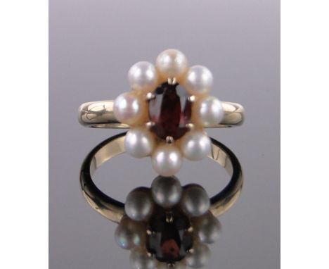 A 9ct gold garnet and pearl cluster ring,setting height 15mm, size R.