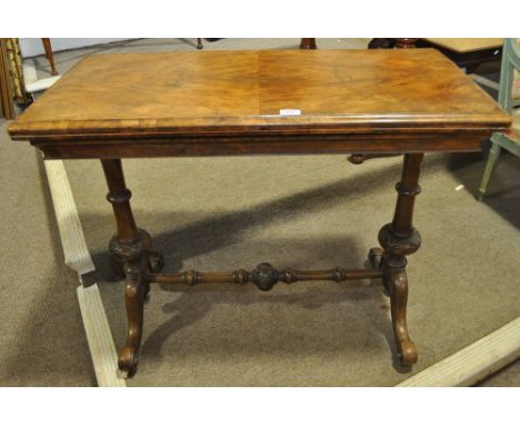 A 19th century walnut foldover card table on stretcher base,width 3'2", height 2'7", depth 1'7".