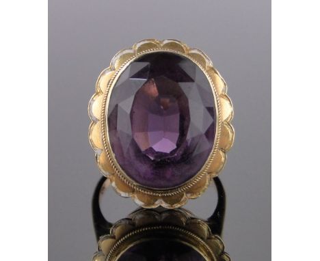 A large amethyst set gold ring,traces of enamel to the surround, high carat gold setting on 9ct shank, setting height 23mm, s