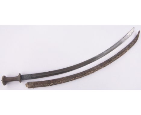 An Ethiopian curved sword,18th/19th century, the blade having embossed portrait and text, carved rhino horn handle, blade len