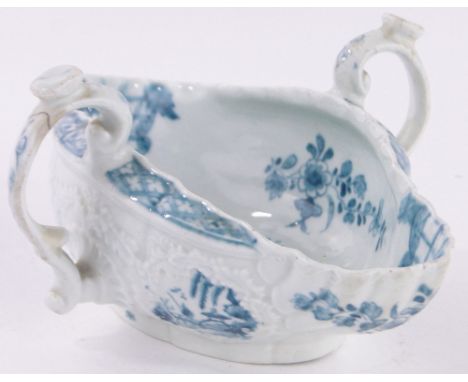 An early English Worcester porcelain 2-handled double lipped sauceboat,relief Rococo style embossed surround with hand painte