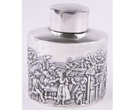 An Edwardian oval silver tea caddy,relief decorated continental village scenes, Birmingham 1903, height 8.5cm.