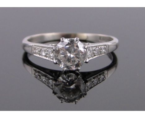 A platinum 0.8ct solitaire diamond ring,diamond set shoulders, size O.