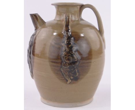 A Chinese brown glaze ceramic teapot,relief embossed figure decoration, height 17cm.