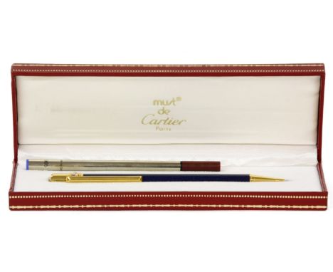 A Must de Cartier ballpoint pen, lapis lazuli effect body with gold-tone finials, in presentation box, and extra cartridges