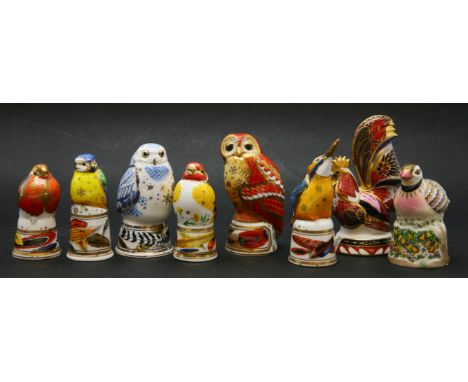 A collection of various Royal Worcester porcelain candlesnuffers in the forms of birds, consisting of a snowy owl, goldfinch,