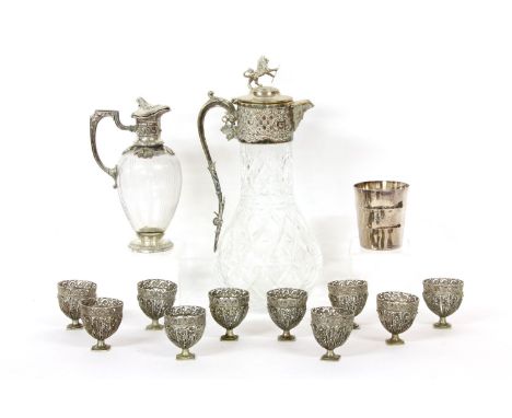 A silver plated claret jug, a creme de menthe jug, ten filigree egg cups and a Christofle beaker