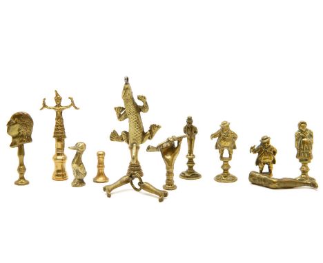 A quantity of Victorian brass novelty pipe tampers, including leg examples