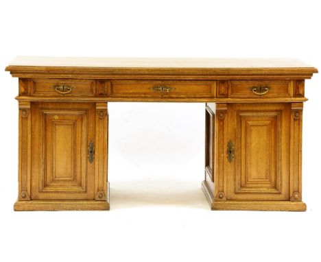 An early 20th century Continental light oak pedestal desk, 150cm wide, 82cm deep, 71cm high