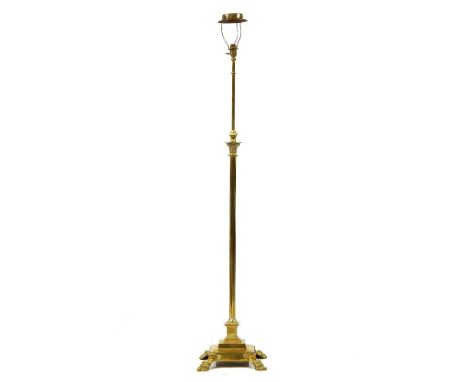 An adjustable brass standard lamp, early 20th century of corinthium column form, on square stepped base and paw feet, 146cm h
