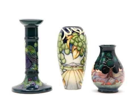 A Moorcroft vase 2003, by Emma Bossons, numbered 35/150, 18.5cm high, another vase, 13cm high and a candlestick, 20.5cm high 