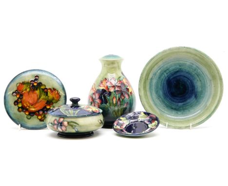 A Moorcroft lamp base, 19cm, and a powder pot and cover, 14cm diameter, a dish, a pot cover and a saucer