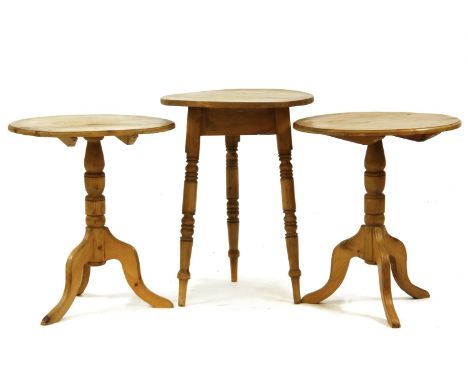 A pair of pine occasional tables each on turned support and tripod base, each 56cm diameter, 66cm high, together with a pine 