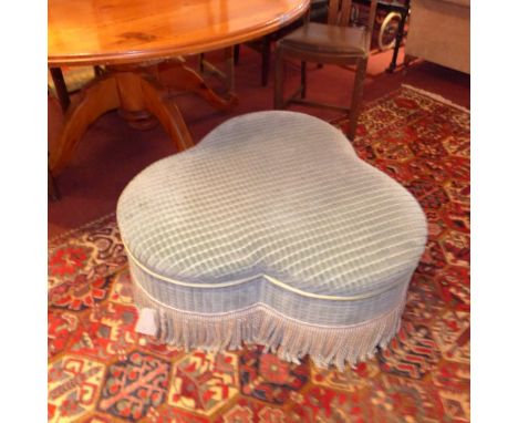 A C20th triform pouffe upholstered in blue fabric