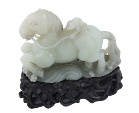 A CHINESE PALE CELADON JADE MONKEY AND HORSE GROUPthe figure of the horse looks forward as it is flying over curling waves, s