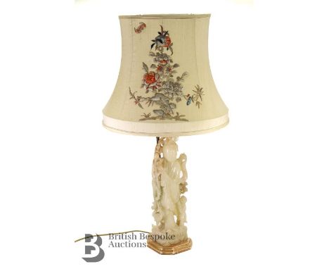 Chinese antique lamp base of Guanyin, depicted in flowing robes with further detail including a cluster of peaches and a hero
