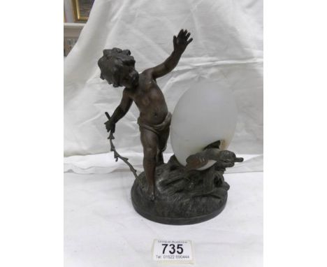 A cherub and hatching egg light